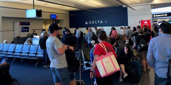 Dozens of Delta passengers have been stranded at the Atlanta airport for more than 24 hours, as airlines struggle to overcome mounting cancellations and delays
