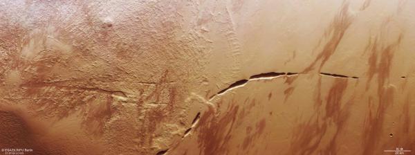 photo of Mars-Orbiting Spacecraft Captures ‘Snaking Scar’ Across the Base of Enormous Volcano image