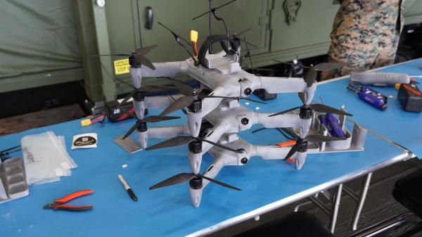 photo of US Navy 3D prints combat-ready drones and 1,000+ parts aboard aircraft carrier during exercise — containerized factory&hellip; image