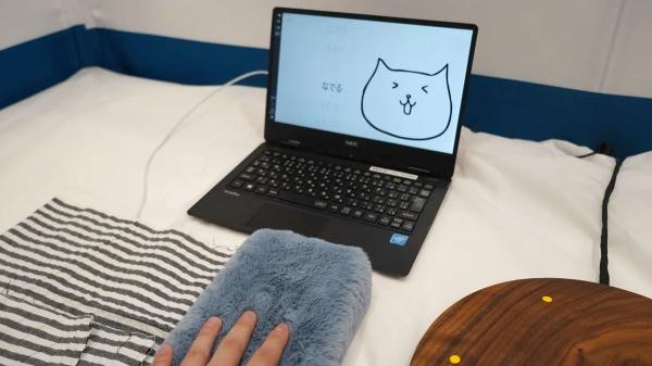 photo of Japanese firm demos tech that makes any object a capacitive touch surface — stuffed cat on display, works with wood,… image