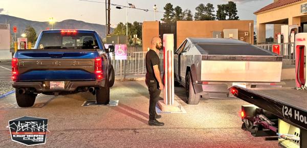 photo of Tesla Cybertruck breaking down at Supercharger gives size comparison with F150 Raptor image