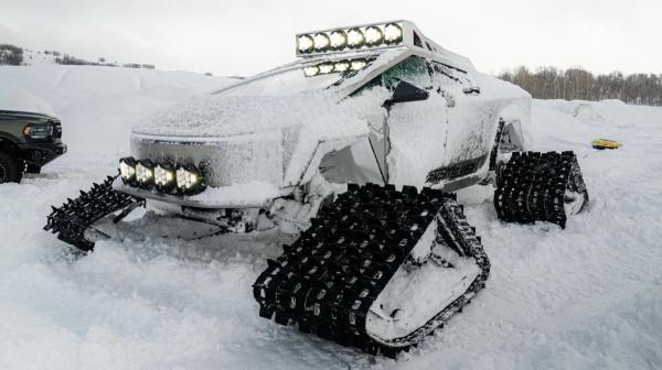 photo of Tesla Cybertruck turns into a tank with massive snow tracks image