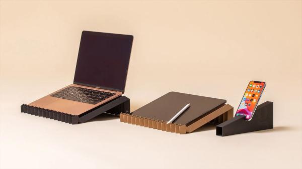 photo of Laptop stand created from a single sheet of recycled paper supports up to 10 pounds — the included cardboard case also… image