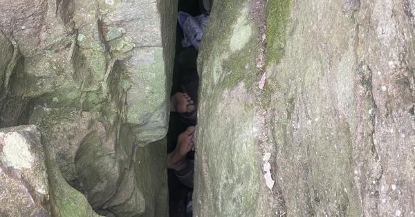 Woman stuck upside down under rock for…